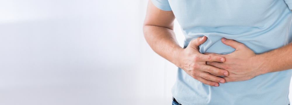 man holding his stomach with both hands