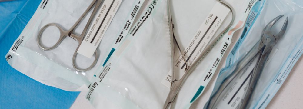 surgical instruments spread out on blue tray